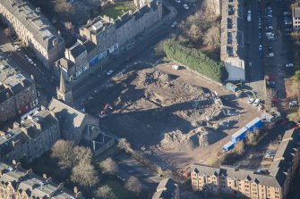 Oblique aerial view of the construction of Student flats in St Leonard's Street and the Roman Catholic Church of St Margaret and St Leonard, looking W.