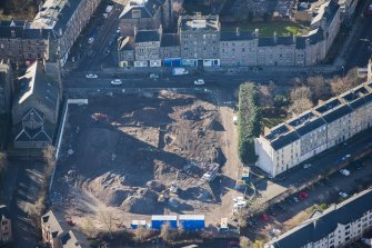Oblique aerial view of the construction of Student flats in St Leonard's Street and the Roman Catholic Church of St Margaret and St Leonard, looking S.