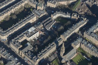 Oblique aerial view of the construction of student flats on the site of the former printing works and John Sinclair House, looking NNE.