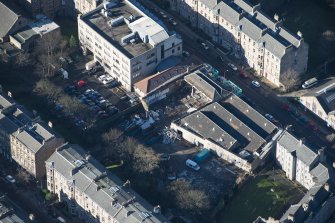 Oblique aerial view of the construction of student flats on the site of the former printing works and John Sinclair House, looking WNW.