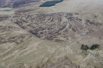 Oblique aerial view of military remains, tracks and rig and furrow at Sheriff Muir, looking NE.