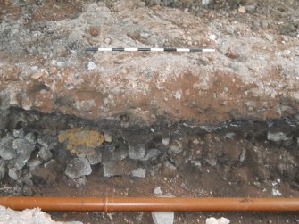 Trench section showing re-deposited loam over concrete and rubble, photograph from archaeological evaluation at Edinburgh Napier University, Merchiston Campus