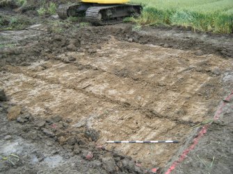 Excavation to intermediary orange clay, photograph from archaeological watching brief at Southfield Farm, Dalkeith