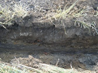 Section of the cable trench at the east end showing the tile drain, photograph from archaeological watching brief at Southfield Farm, Dalkeith