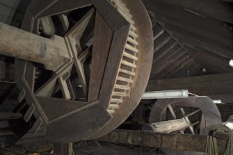 3rd floor (grid). Fly tower. Detail of wooden winding drums and shafts.