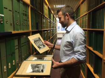 Philip Graham looking at photographs in the HES Search Room at John Sinclair House, 16 Bernard Terrace, Edinburgh