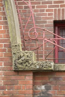 Detail of carving and ironwork on entrance stair.