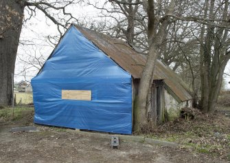 General view from south showing end of timber building.