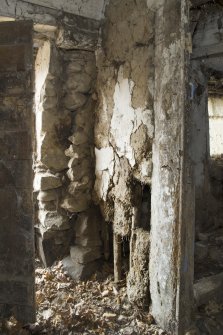 Detail of interior wall construction showing wattle and dawb.