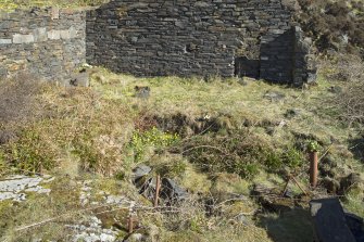 Building to north of boiler house, detail of plinth, riser pipe, bracket and sunken pit