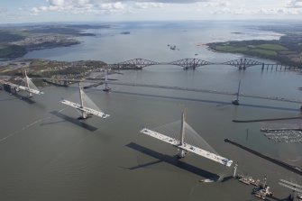 Oblique aerial view of the Forth Bridge, the Forth Road Bridge and the construction of the Queensferry Crossing, looking E.