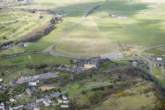 Oblique aerial view of Stirling Castle, King's Knot and former Raploch Airfield, looking SW.