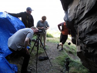 Members of the ACCORD project undertaking RTI recodng of graffiti at Dumbarton Rock.