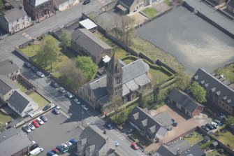 Oblique aerial view of St Ignatius' Catholic Church, looking E.