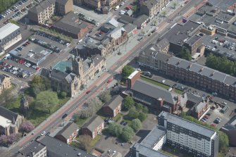 Oblique aerial view of St Columbkille's Roman Catholic Church and Rutherglen Town Hall, looking NE.