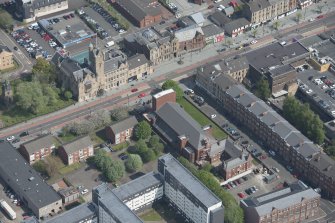 Oblique aerial view of St Columbkille's Roman Catholic Church and Rutherglen Town Hall, looking NNE.