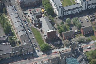 Oblique aerial view of St Columbkille's Roman Catholic Church and Rutherglen Town Hall, looking SSW.