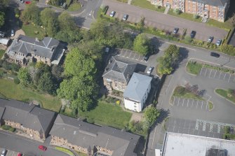 Oblique aerial view of 23, 25 and 25A Mansionhouse Road, looking NW.