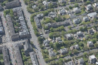 Oblique aerial view of Pollokshields Parish Church, The Knowe villa and lodge, looking SSW.