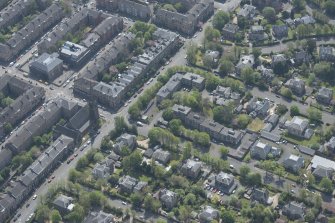 Oblique aerial view of Pollokshields Parish Church, The Knowe villa and lodge, looking SSE.