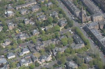 Oblique aerial view of Pollokshields Parish Church, The Knowe villa and lodge, looking ENE.