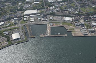 Oblique aerial view of the former sites of the Cartsburn, Greenock and Cartsdyke Shipyards, looking SW.