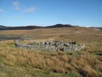 General view of the excavated and consolidated wheelhouse at Grimsay, surrounded by a modern dyke, facing east.