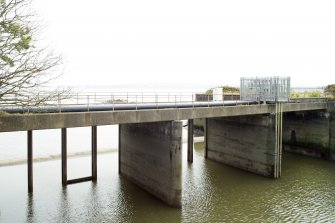General view of sluice from north. This water cooling channel or flume outflow (1.5 km in length from seal pumps to sluice gates to the east) cools the process water prior to its entering into the River Forth.