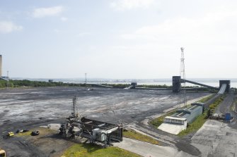 General view of coal stock area from north west. On right, conveyor originally fed by NCB Buffer Hopper (from Longannet Mine, closed 2002) and Vehicle Coal Discharge hopper. This area had been cleared of coal stocks by the time of survey.
