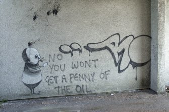 General view of graffiti art by Stormie Mills (character) and tag (Remi Rough), with later writing.