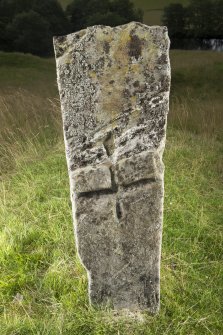 View of upright slab with incised cross in middle of stone