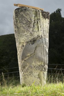 View of upright slab with incised cross at top of stone (including scale)