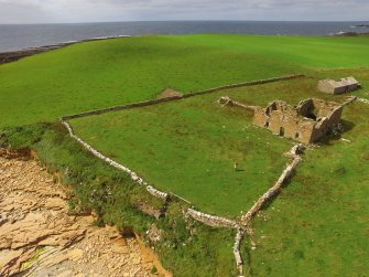 Oblique aerial view of Breckness House, the site of the chapel, and part of the broch.