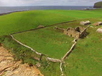 Oblique aerial view of Breckness House, the site of the chapel, and part of the broch.