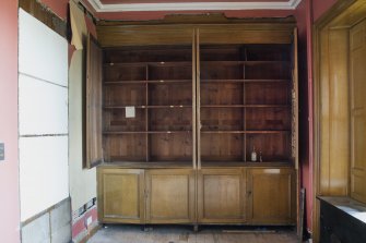 Ground floor. North room (library). Detail of bookcases. Doors open.