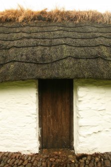 Detail of  thatched roof showing rope supports and overgrown ridge; cruck-framed cottage, Torthorwald.