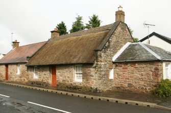 View of 18th century semi detached cottages, showing east cottage with thatched roof and reed thatched ridge; Longforgan Main Street.