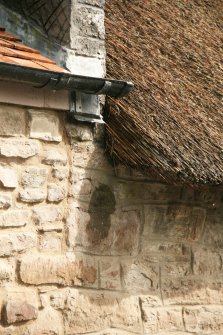 Detail of  roofing on semi detached cottages showing corner of thatch adjoining red tiles; Quoins Cottage, Longforgan Main Street.