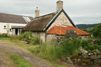 General view of restored probable 18th century cruck framed  cottage with thatched roof; East Cottage Nether Tullicro, Dull.