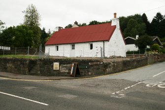 Side view of single storey formerly thatched cottage with corrugated iron roof; Atholl Road, Pitlochry.