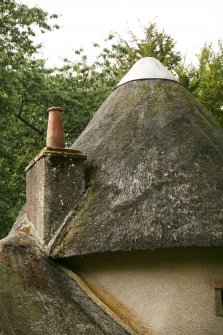 View of chimney stack and metal cap on conical section of thatch; Norman Cottage, Mellerstain House.