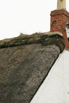 Detail of thatched roof, ridge and chimney, late 18th century  cottage; Rowantree Cottage, Main Street, Kirk Yetholm.
