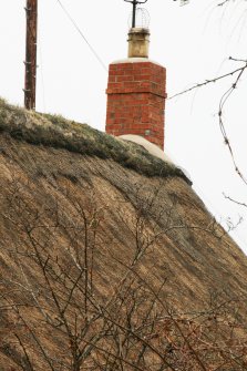 Detail of thatched roof, ridge and chimney, late 18th century  cottage; Rowantree Cottage, Main Street, Kirk Yetholm.