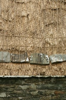 Detail of roof showing netting and stone weights; Southvoe croft house museum, Shetland.