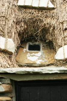Detail of thatching and stonework around window; Southvoe croft house museum, Shetland.