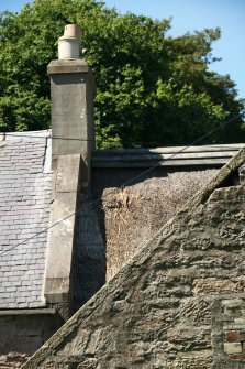 View of chimney stack and ridge, damaged thatch, and adjoining roofs; Soutar Johnnie's cottage, Kirkoswald.