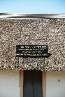 View of doorway showing  timber plank ridged roof;  Robert Burns Cottage, Alloway.