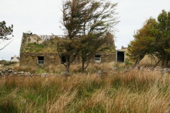 View of derelict 19th century cottage with deteriorating remnants of formerly thatched roof; Melvaig.