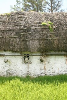 View of deteriorating thatched roof showing metal poles and stone weights; 12 Lower Ardelve.