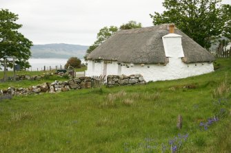 View of restored 19th century cottage with plended reed thatched roof; 2 Luib, Skye.